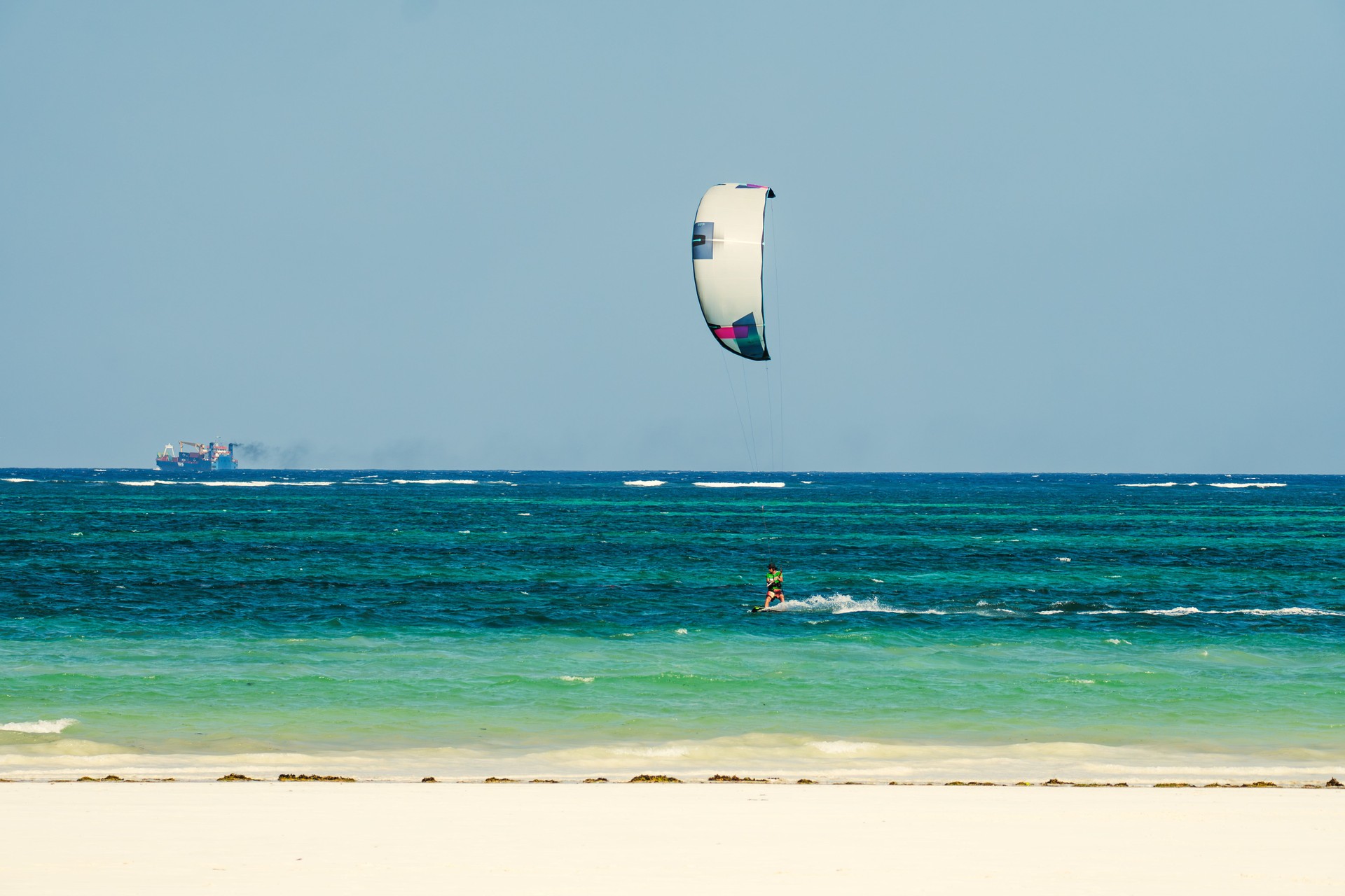 kiteboarder kitesurfer athlete performing kitesurfing kiteboarding. Diani Beach, Kenya, Mombasa.