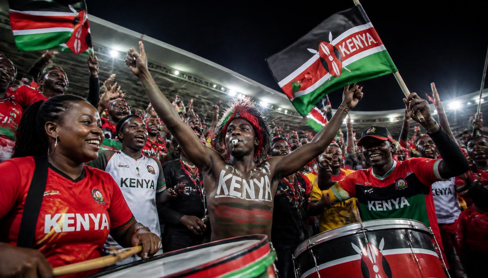 Kenyan supporters in national colours cheering in a stadium